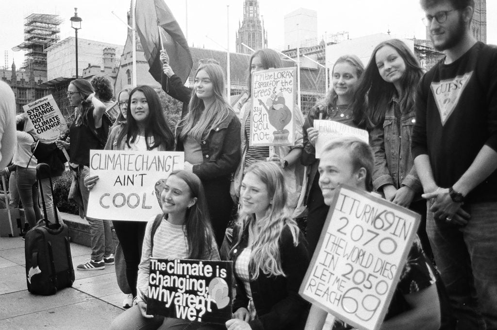 a photo at the SCHOOL STRIKE FOR CLIMATE of Some students with their banners.