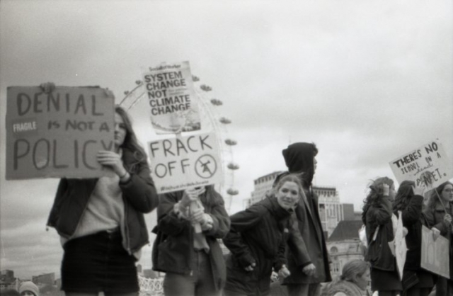 people standing holding signs during a protest in london